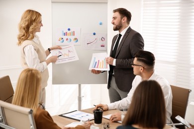 Photo of Businesspeople having meeting in office. Management consulting