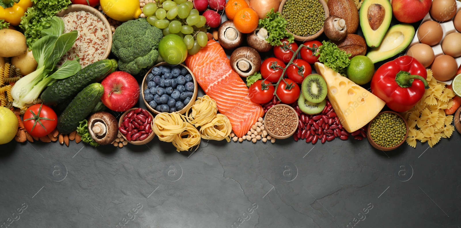 Photo of Different products on black table, top view with space for text. Healthy food and balanced diet