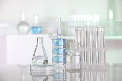 Laboratory analysis. Different glassware with liquid on white table indoors