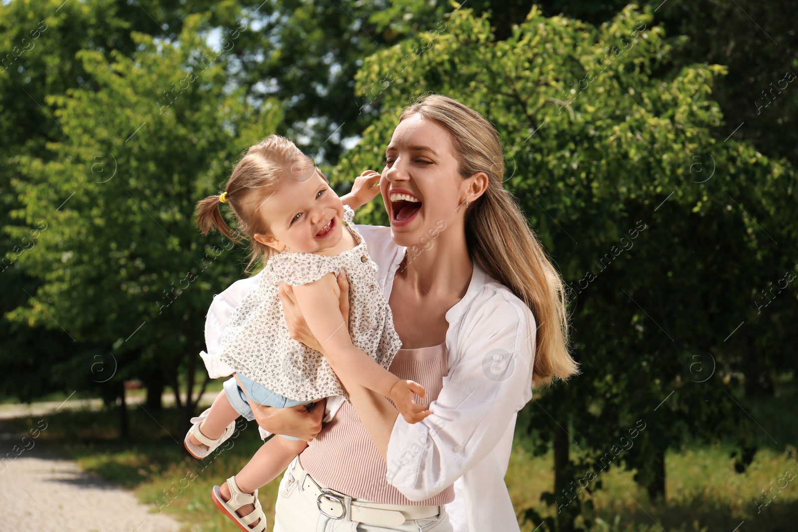 Photo of Happy mother with her daughter having fun in park