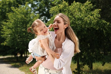 Photo of Happy mother with her daughter having fun in park