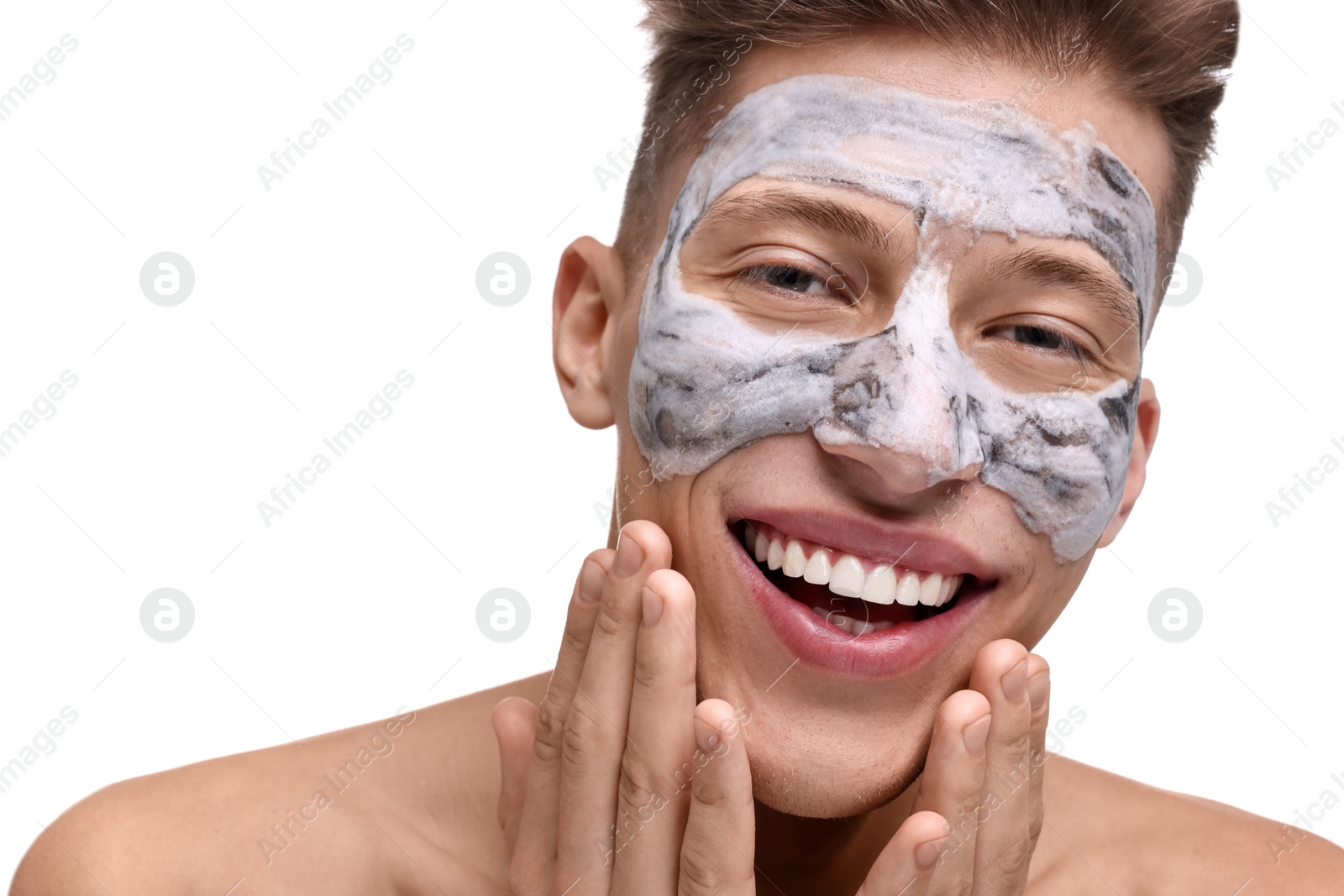 Photo of Handsome man with clay mask on his face against white background, closeup