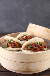 Delicious gua bao (pork belly buns) on wooden table, closeup