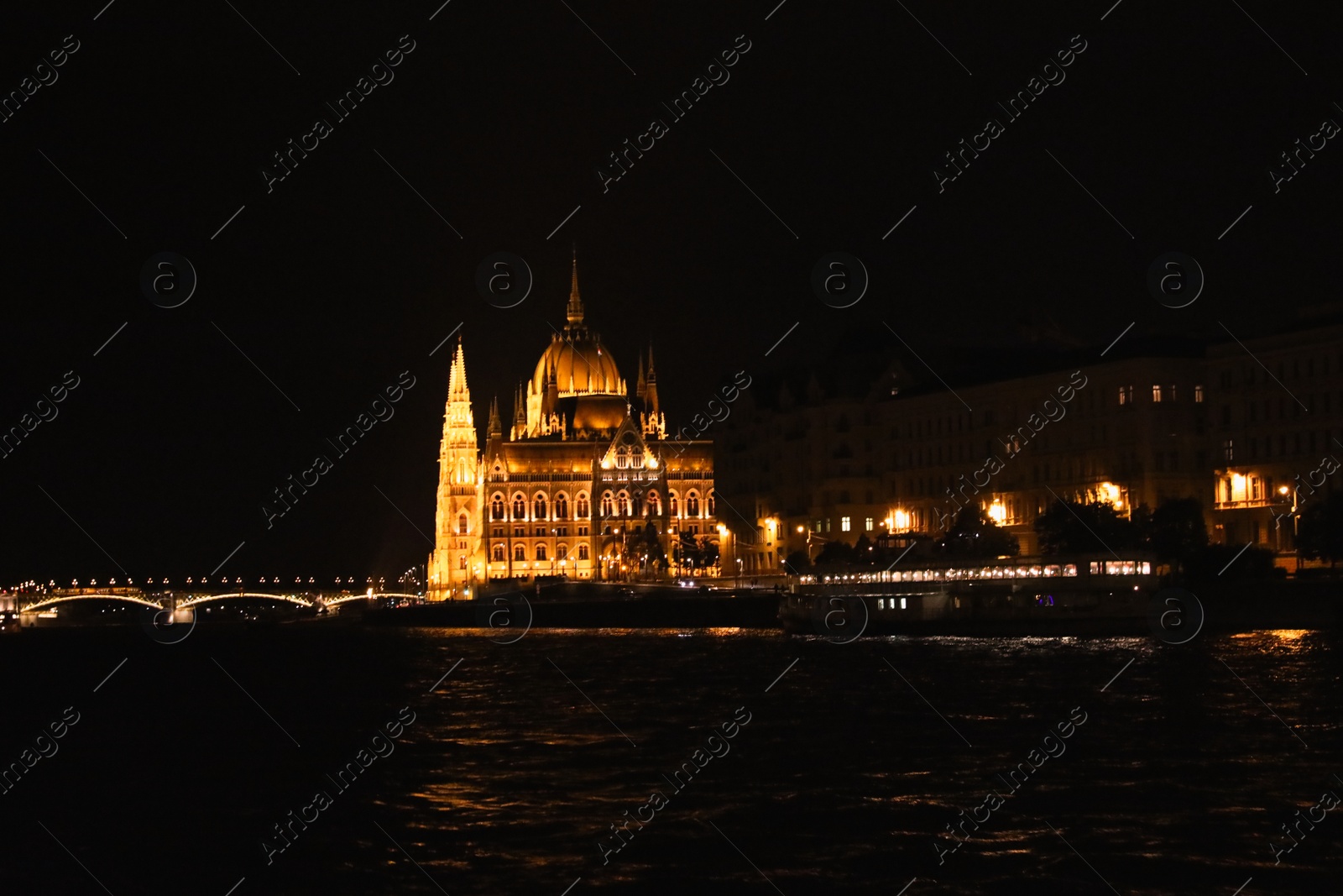 Photo of BUDAPEST, HUNGARY - APRIL 27, 2019: Beautiful night cityscape with illuminated Parliament Building and Margaret Bridge across Danube river