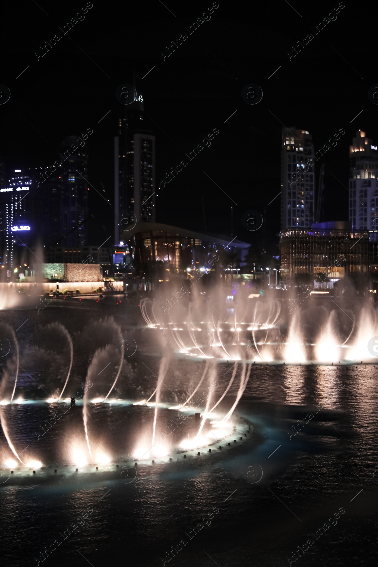 Photo of DUBAI, UNITED ARAB EMIRATES - NOVEMBER 04, 2018: Famous dancing fountain show on Burj Khalifa lake at night