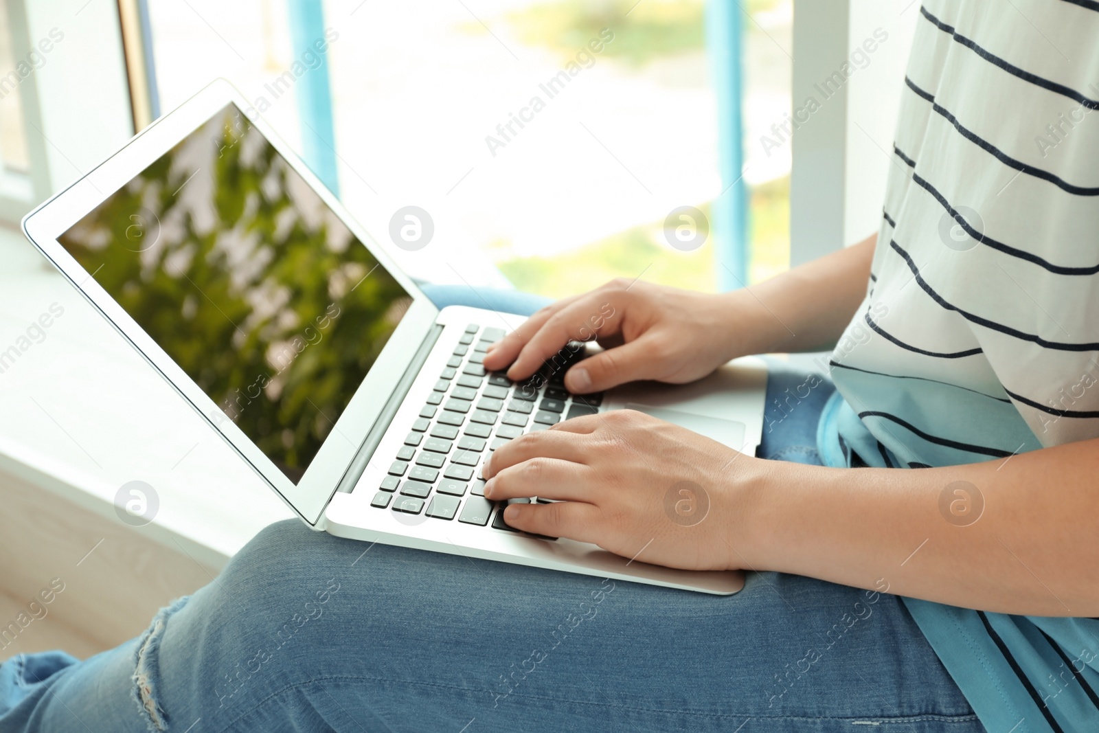 Photo of Man in casual clothes with laptop indoors