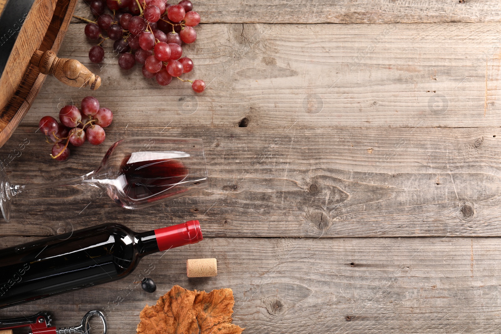 Photo of Winemaking. Flat lay composition with tasty wine and barrel on wooden table, space for text