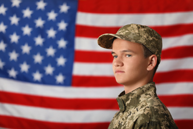 Photo of Male soldier in uniform against USA flag