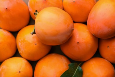 Photo of Delicious ripe juicy persimmons as background, top view