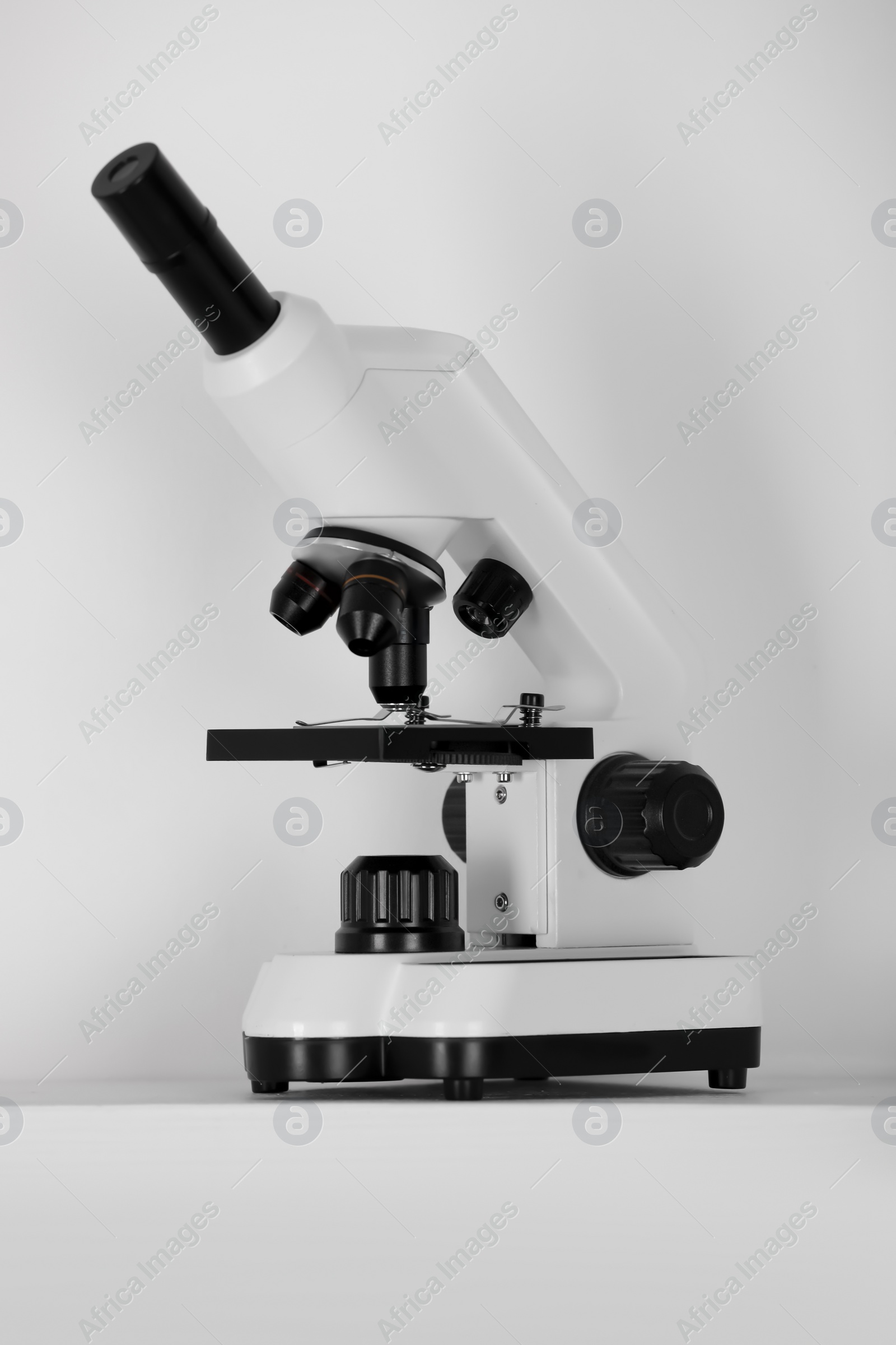 Photo of Modern microscope on light background. Medical equipment