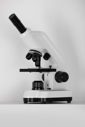 Modern microscope on light background. Medical equipment