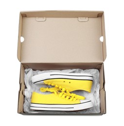 Photo of Pair of stylish sport shoes in cardboard box on white background, top view