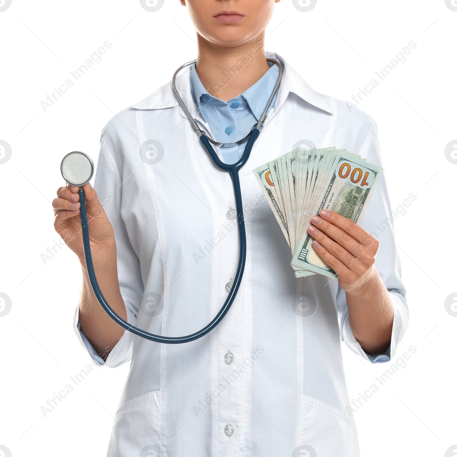 Photo of Doctor with bribe and stethoscope on white background, closeup. Corruption in medicine