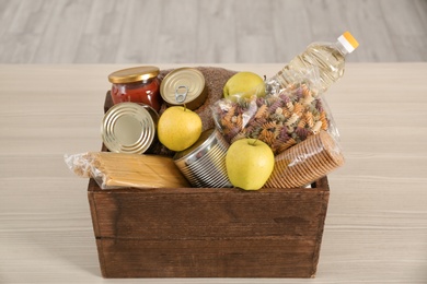 Photo of Donation box with food on table indoors