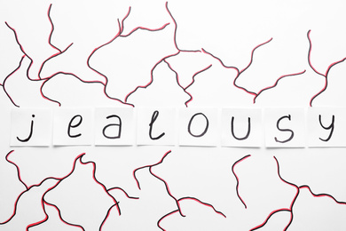 Word JEALOUSY made with paper notes on white background, flat lay