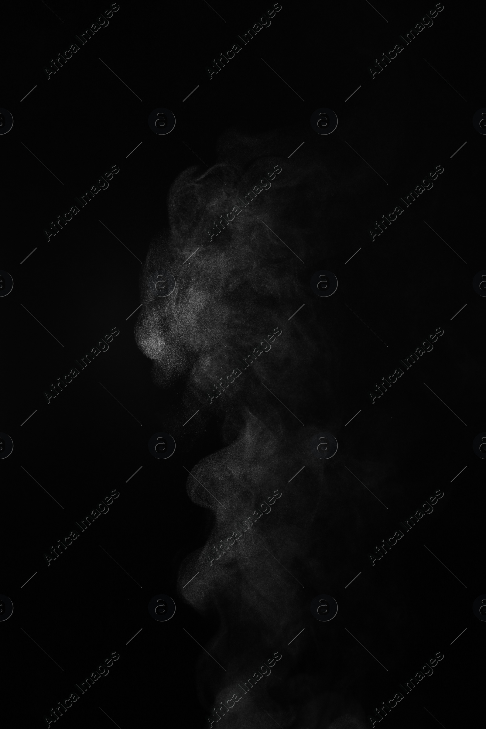 Photo of White steam column rising on black background