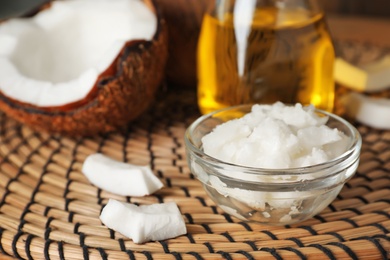 Photo of Bowl with coconut oil on table. Healthy cooking