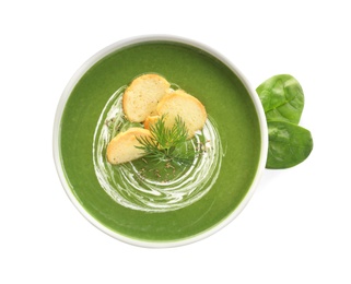 Fresh vegetable detox soup made of spinach with croutons in dish and leaves on white background, top view