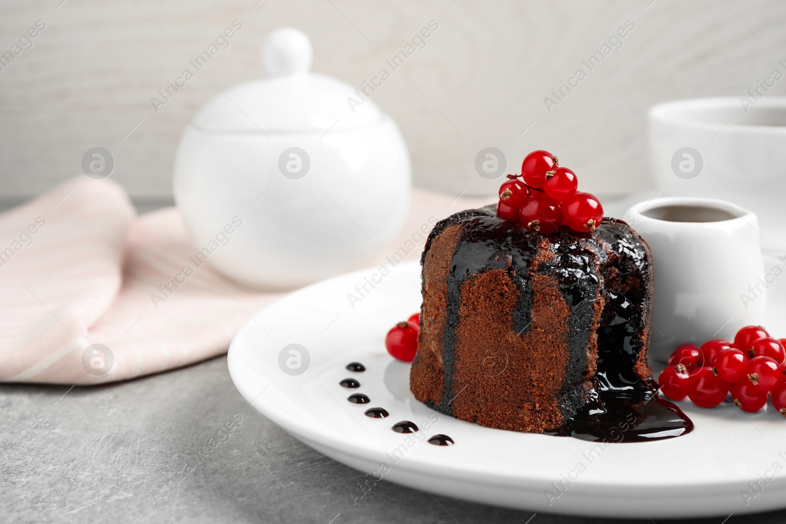 Photo of Delicious warm chocolate lava cake with berries on plate, closeup. Space for text