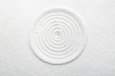 Zen rock garden. Circle pattern on white sand, top view