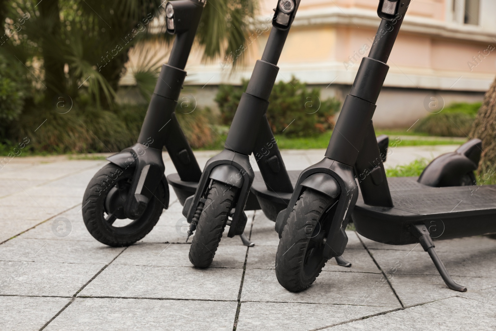 Photo of Row of electric scooters outdoors, closeup. Rental service