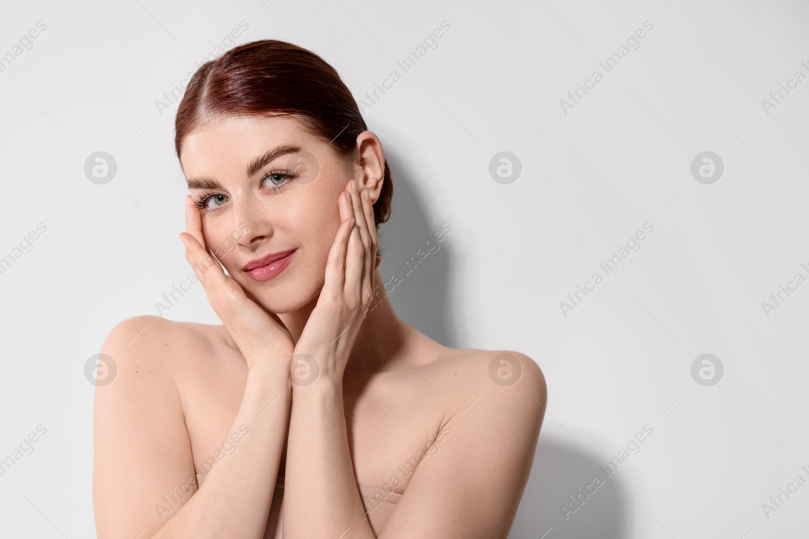 Photo of Portrait of beautiful woman on light background. Space for text