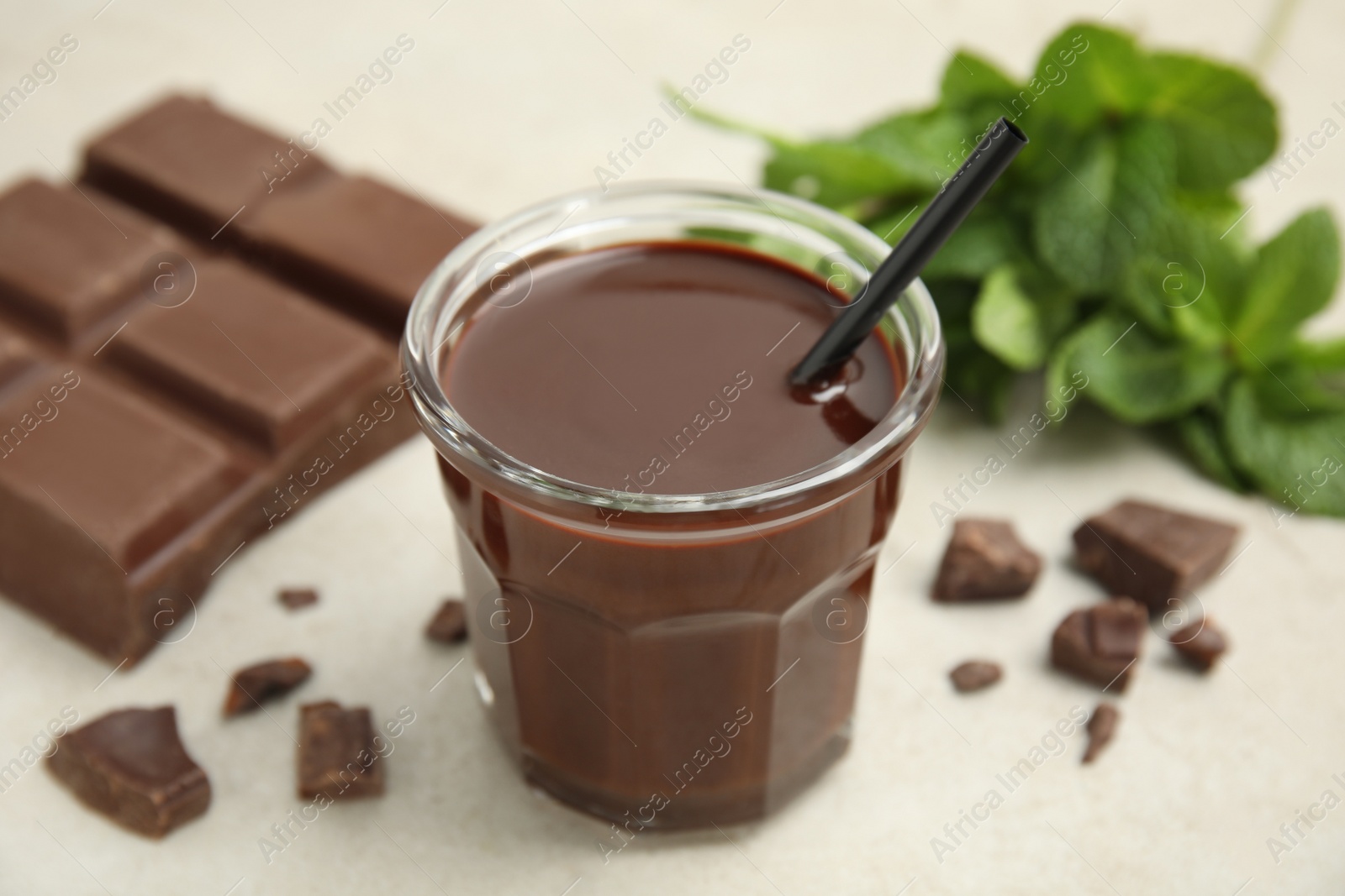 Photo of Glass of delicious hot chocolate on light table