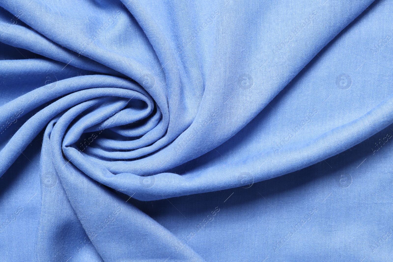 Photo of Texture of light blue crumpled fabric as background, top view