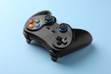 Photo of Wireless game controller on light blue background