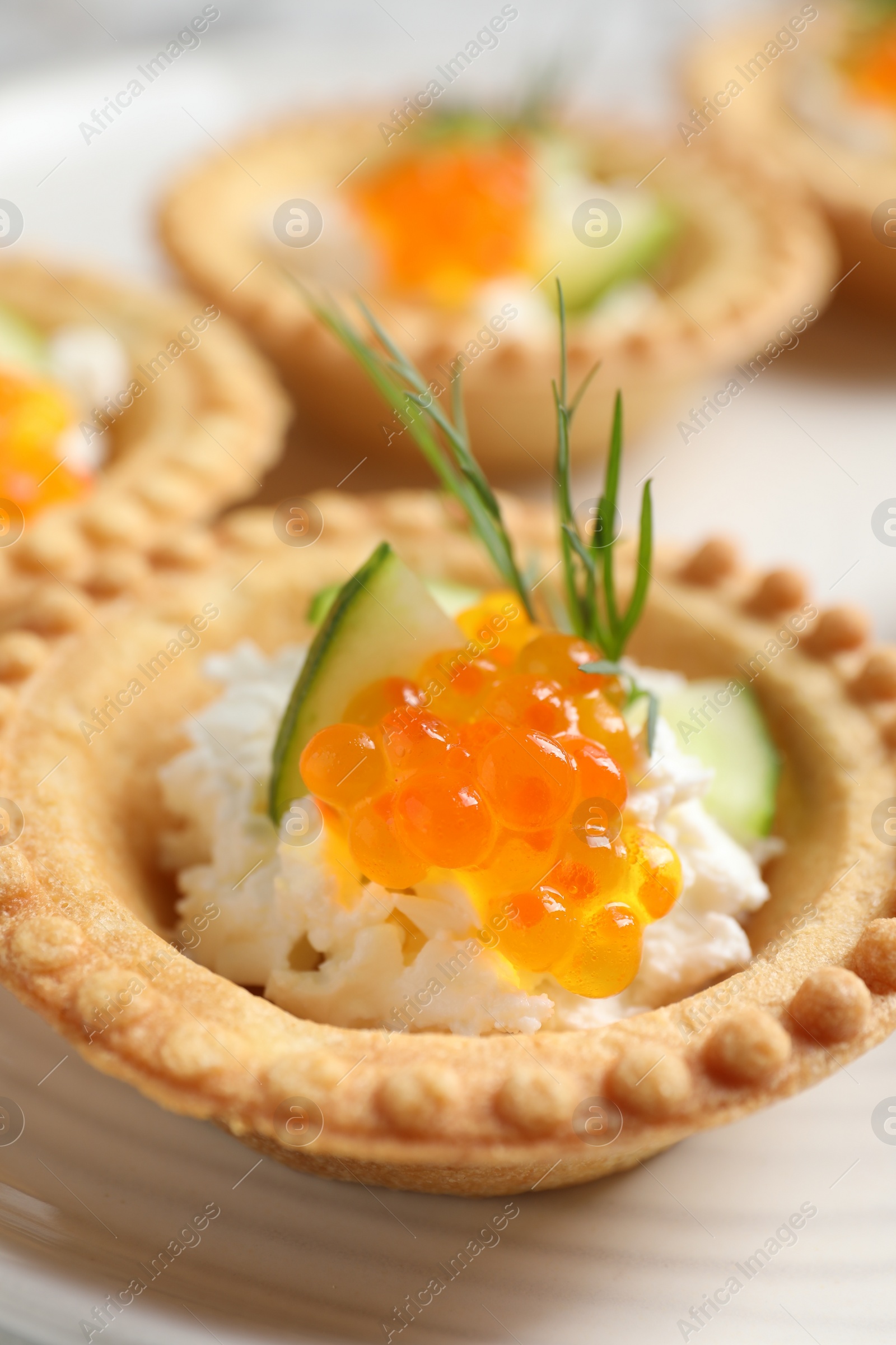 Photo of Delicious canapes with red caviar on plate, closeup