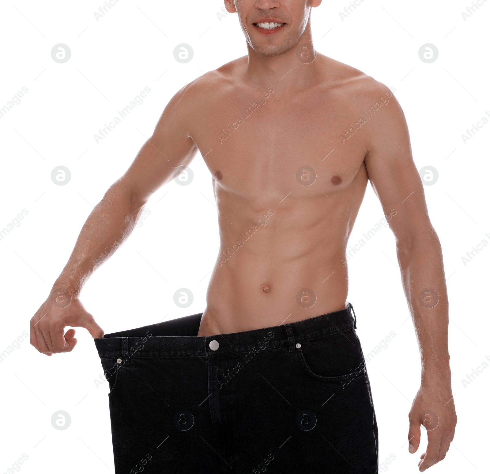 Photo of Shirtless man with slim body wearing big jeans isolated on white, closeup