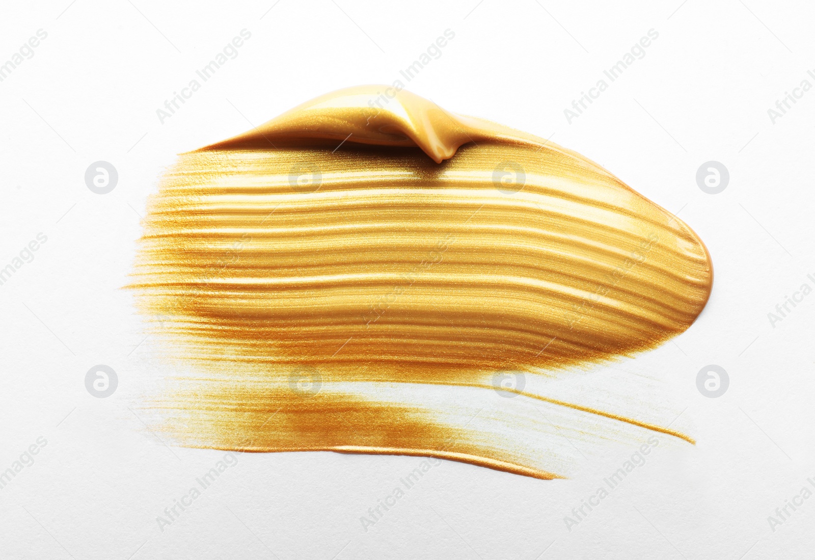 Photo of Stroke of gold paint isolated on white, top view