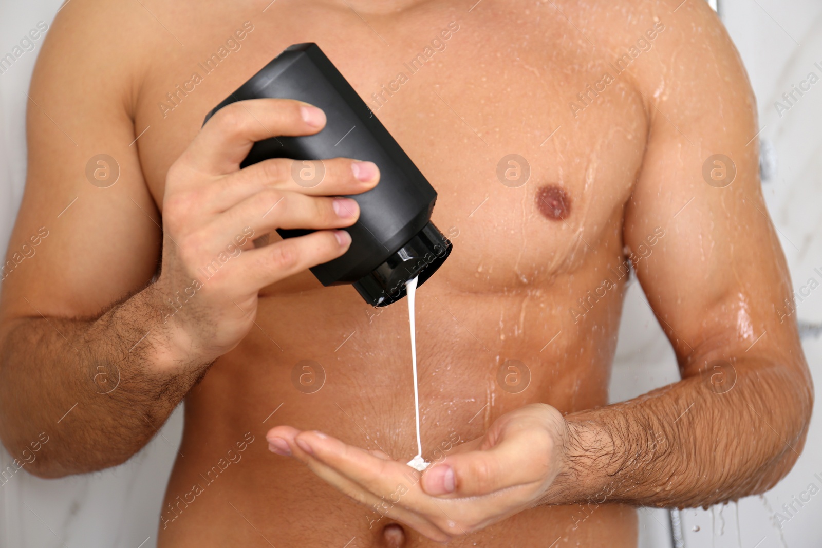 Photo of Man applying gel in shower at home, closeup