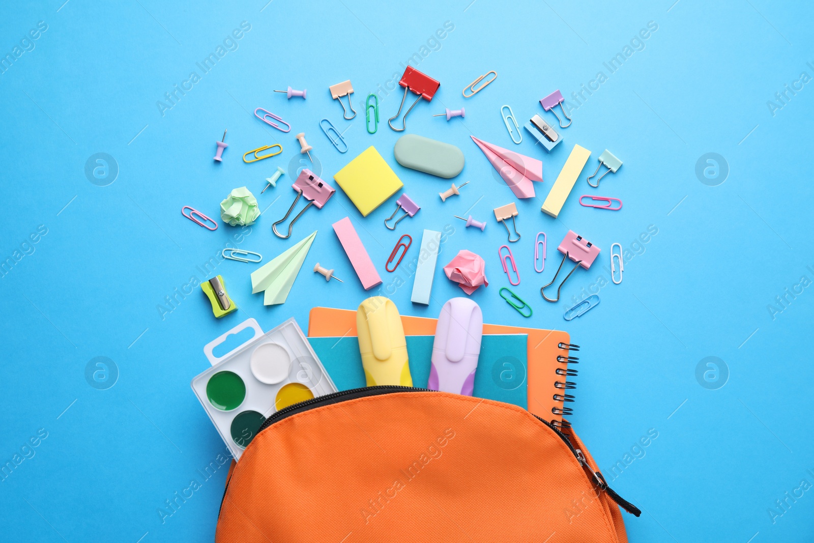 Photo of Back to school. Many different school stationery and paper planes on light blue background, flat lay