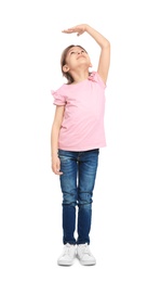 Photo of Little girl measuring her height on white background