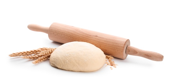 Photo of Raw dough and rolling pin on white background