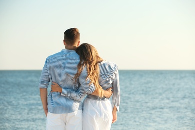 Photo of Happy young couple resting together on beach