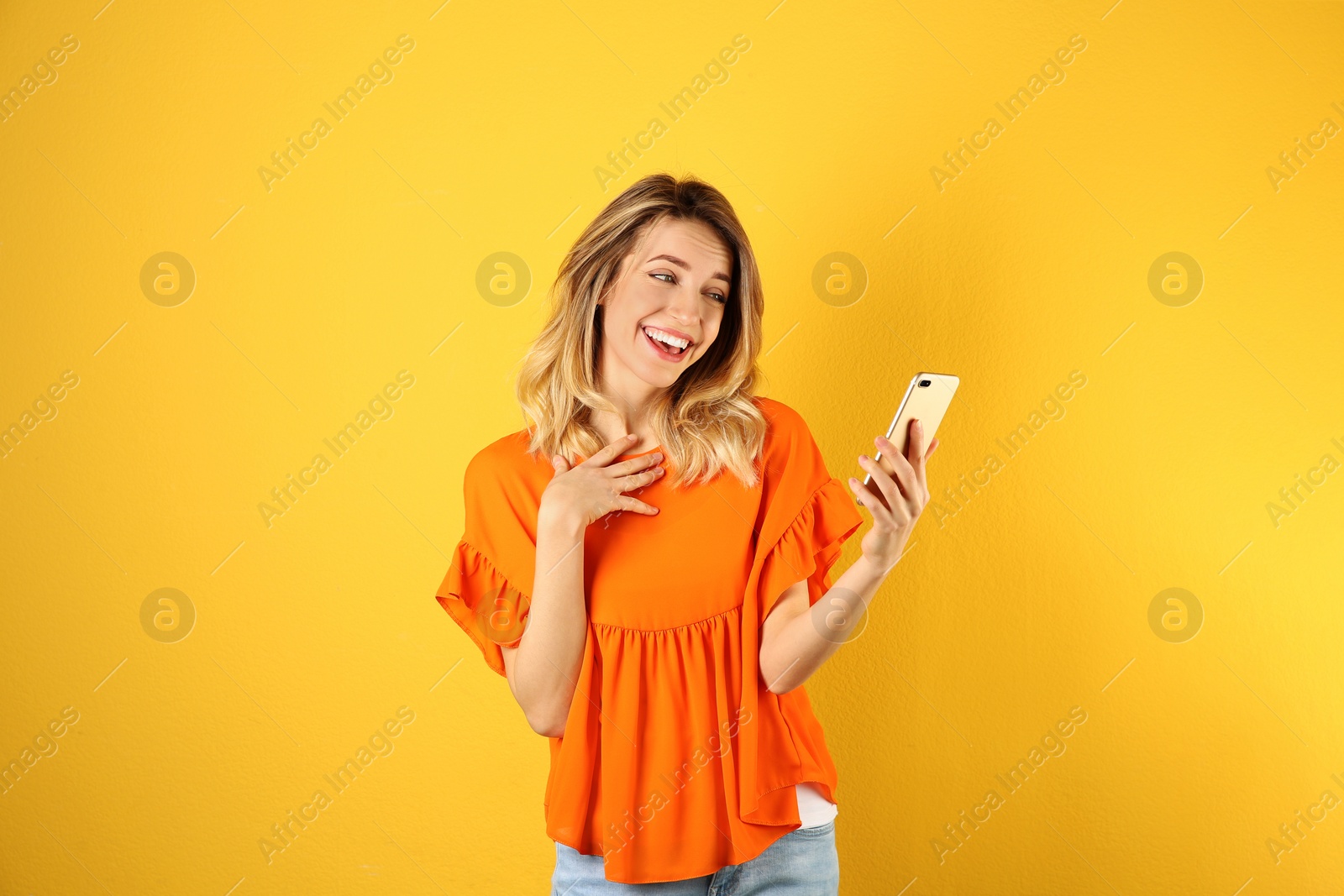 Photo of Woman using mobile phone for video chat on color background