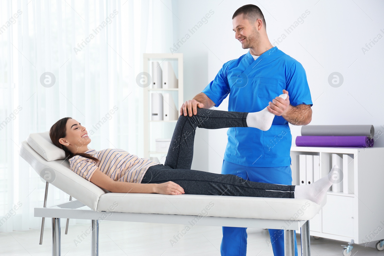 Photo of Doctor working with patient in hospital. Rehabilitation physiotherapy