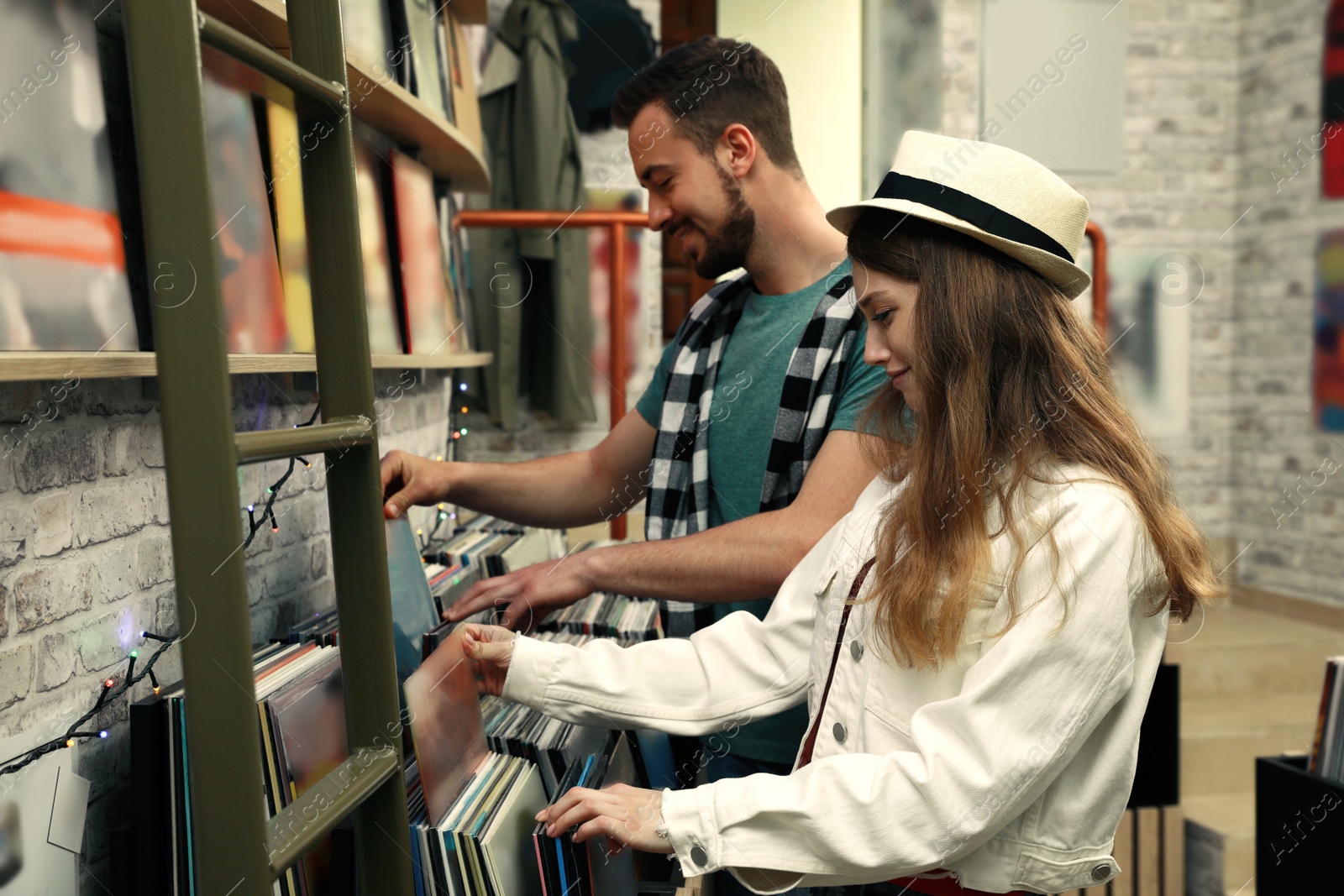 Image of Young people choosing vinyl records in store