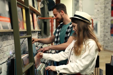 Image of Young people choosing vinyl records in store