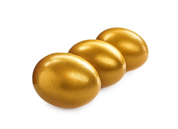 Photo of Many shiny golden eggs on white background