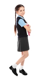 Photo of Full length portrait of cute girl in school uniform with books on white background