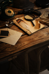 Composition with vintage detective items on wooden table