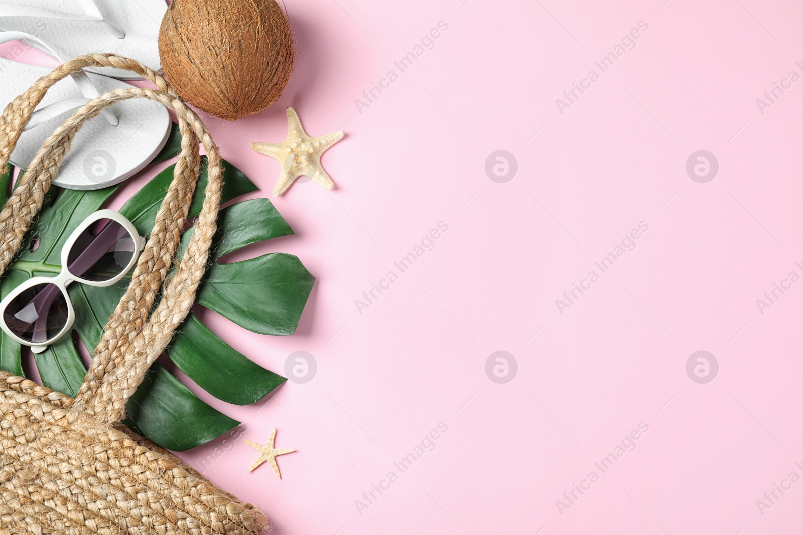 Photo of Composition with beach accessories and space for text on pink background, flat lay