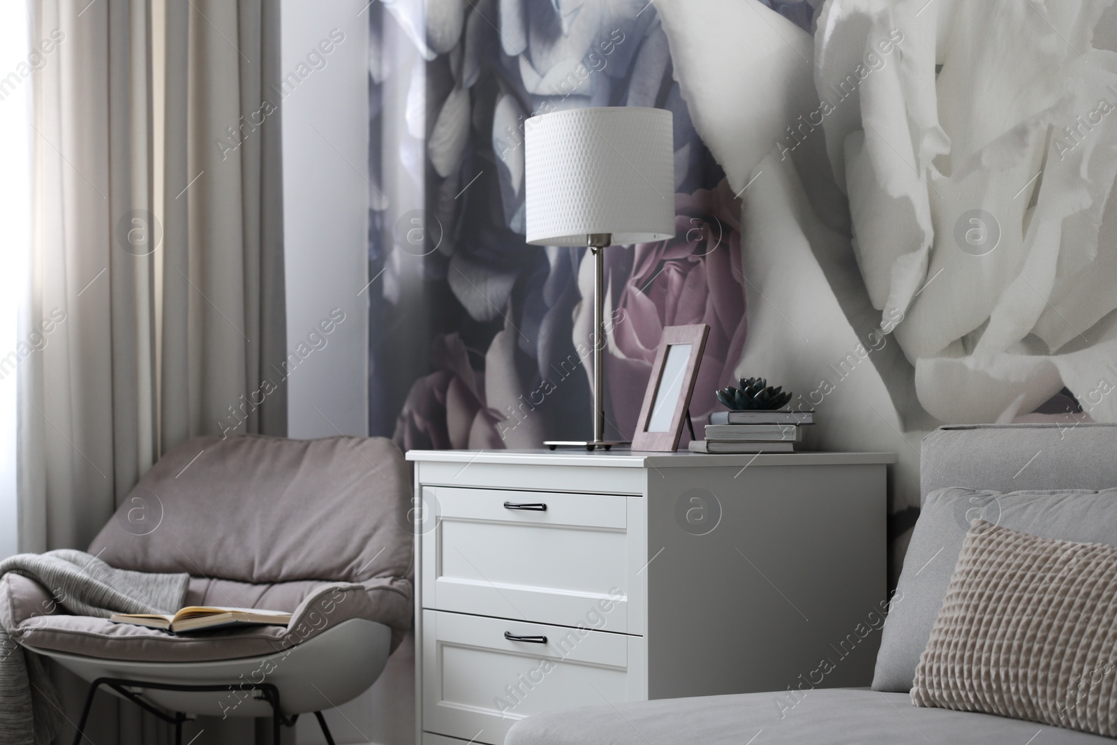 Photo of White chest of drawers in stylish living room. Interior design