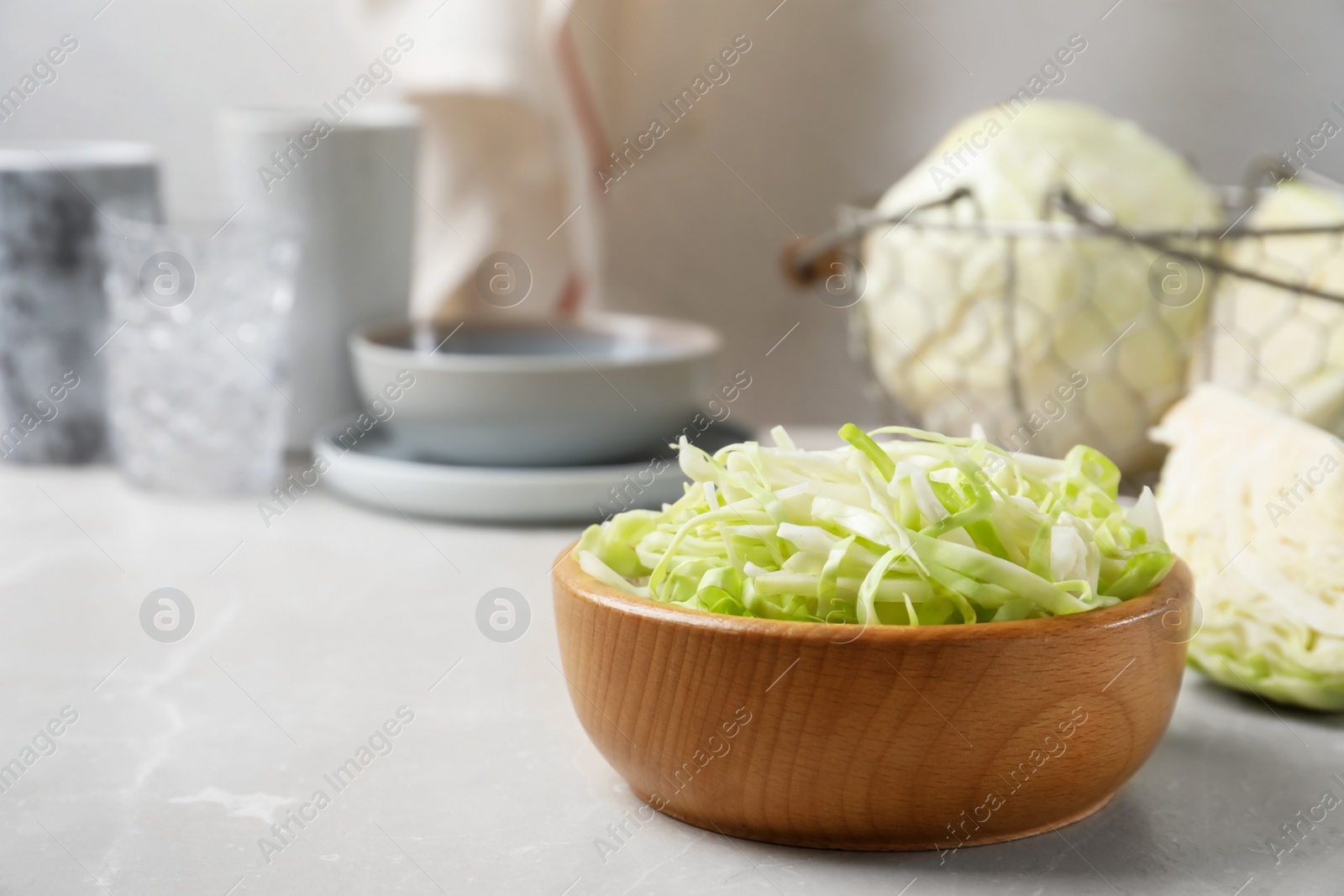 Photo of Fresh shredded cabbage on light table. Space for text