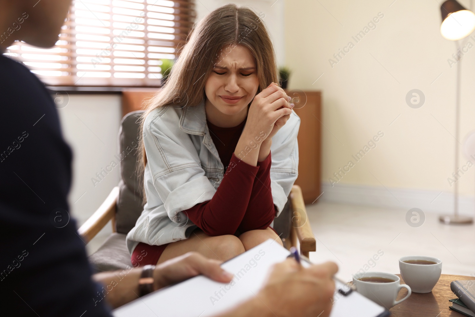 Photo of Professional psychotherapist working with patient in office