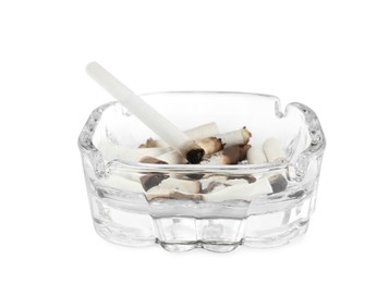 Photo of Glass ashtray with cigarette stubs isolated on white