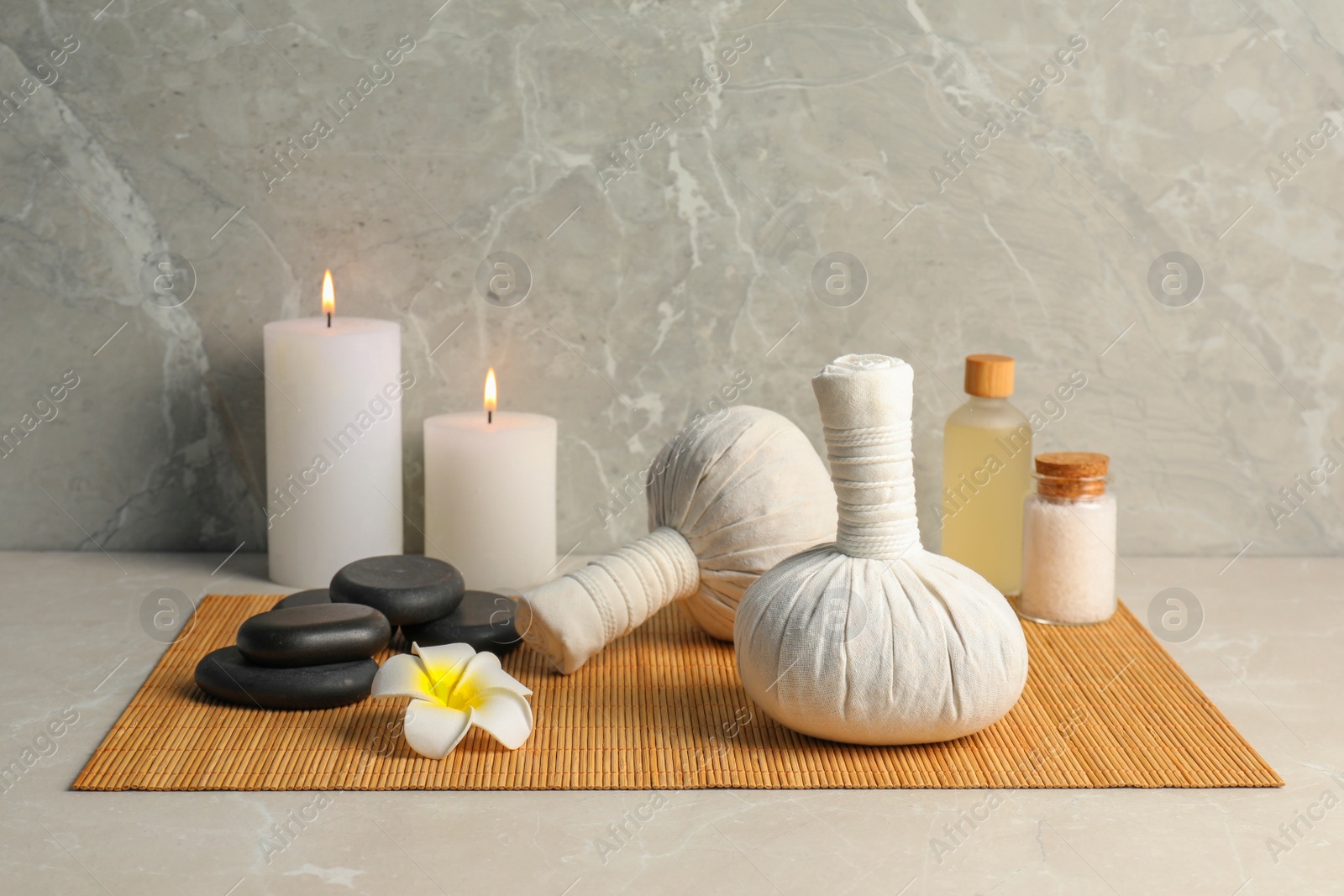 Photo of Spa bags, sea salt and essential oil on light gray table